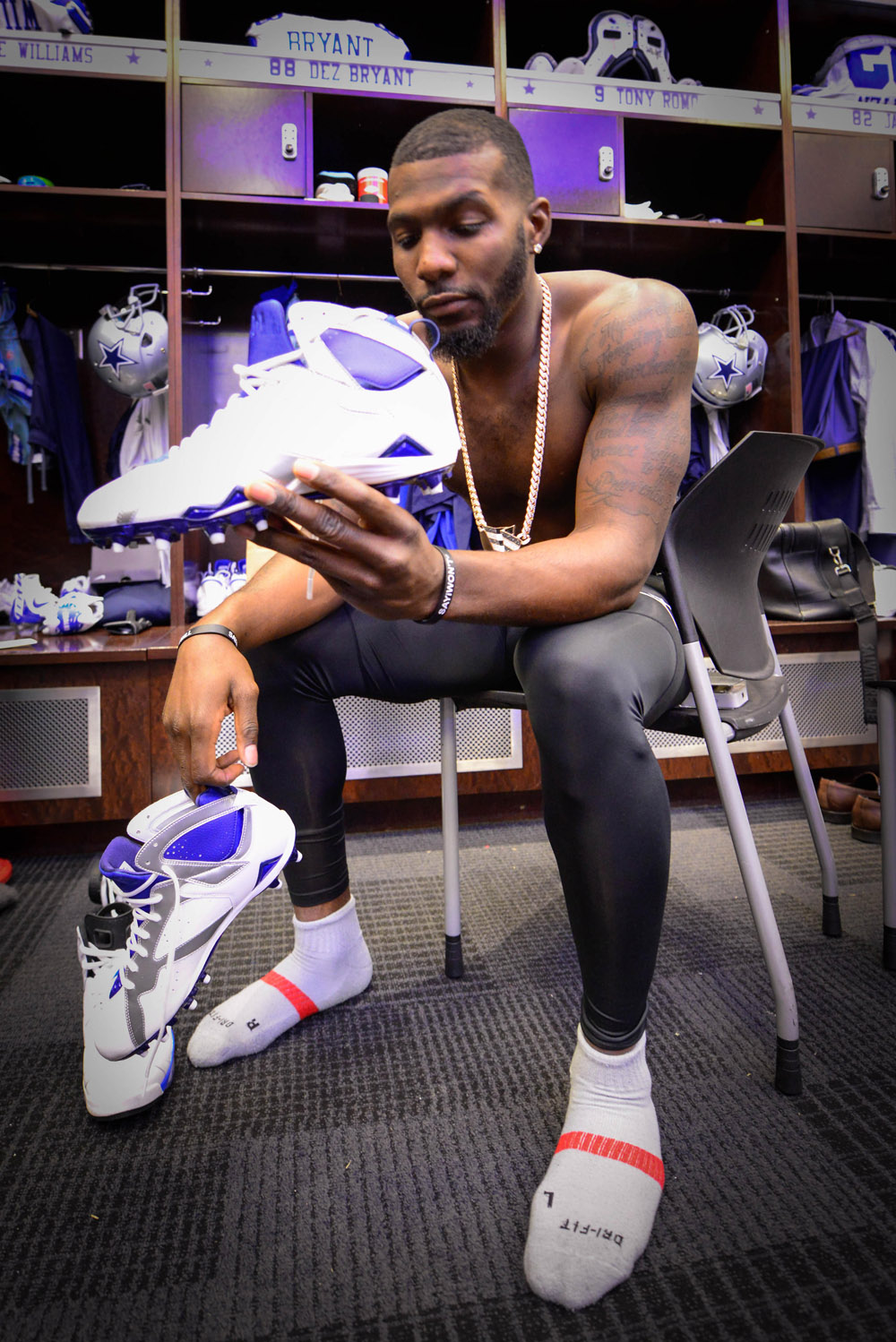 Dez Bryant holding his PE Air Jordan 7 Cleats