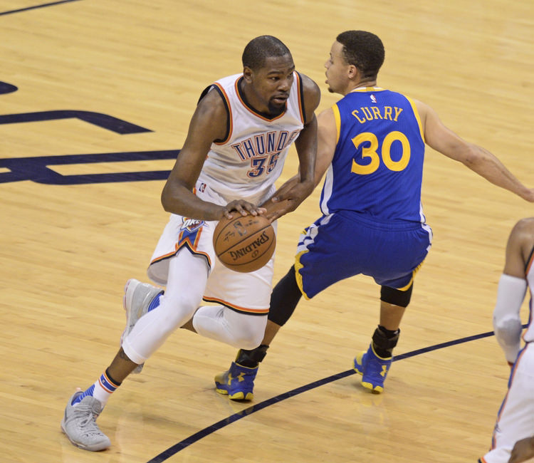 May 22, 2016; Oklahoma City, OK, USA; Oklahoma City Thunder forward Kevin Durant (35) dribbles as Golden State Warriors guard Stephen Curry (30) defends during the second quarter in game three of the Western conference finals of the NBA Playoffs at Chesapeake Energy Arena. Mandatory Credit: Mark D. Smith-USA TODAY Sports