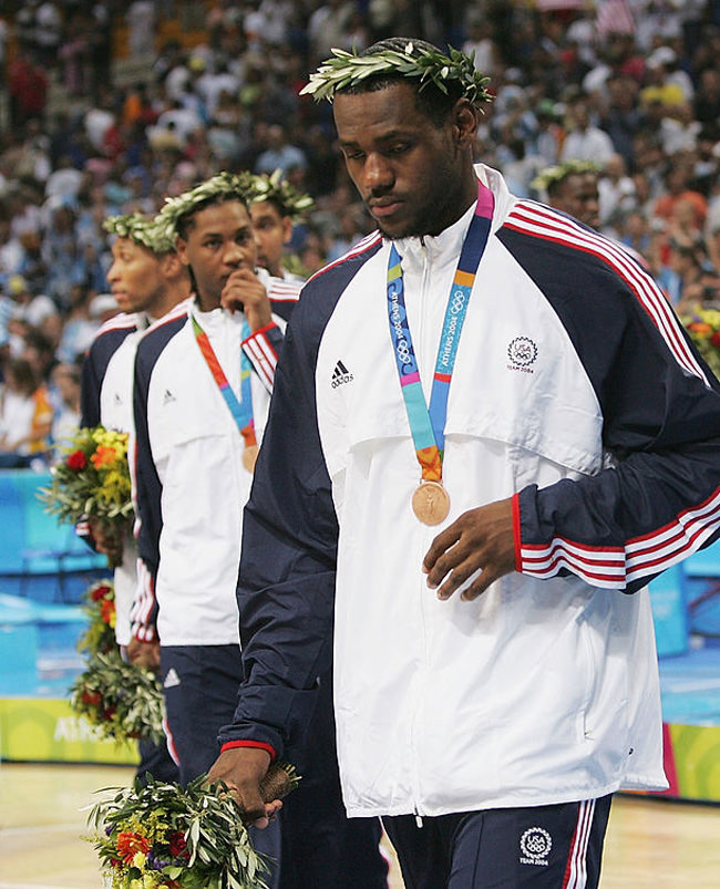 ATHENS - AUGUST 28: LeBron James #9, Carmelo Anthony #8 and Allen Iverson of the United States walk off the court after they receive the bronze medal for men's basketball during ceremonies on August 28, 2004 during the Athens 2004 Summer Olympic Games at the Indoor Hall of the Olympic Sports Complex in Athens, Greece. (Photo by Jamie Squire/Getty Images) *** Local Caption *** LeBron James;Carmelo Anthony;Allen Iverson