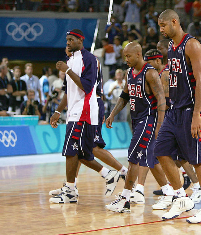 ATHENS - AUGUST 21: Lead by Tim Duncan #13, the United States walks off the court after a loss to Lithuania in a men's basketball preliminary game on August 21, 2004 during the Athens 2004 Summer Olympic Games at the Indoor Arena of the Helliniko Olympic Complex in Athens, Greece. (Photo by Scott Barbour/Getty Images) *** Local Caption *** Tim Duncan;LeBron James;Stephon Marbury