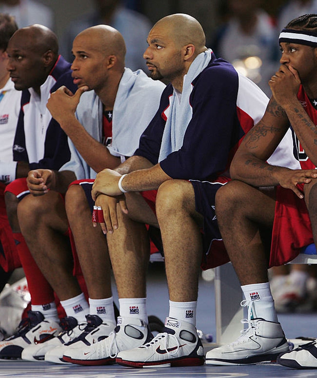 ATHENS - AUGUST 15: Carlos Boozer and Carmelo Anthony of the United States sit with their teammates in the men's basketball preliminary game on August 15, 2004 during the Athens 2004 Summer Olympic Games at the Indoor Arena of the Helliniko Olympic Complex in Athens, Greece. Puerto Rico won 92-73. (Photo by Jamie Squire/Getty Images) *** Local Caption *** Carlos Boozer;Carmelo Anthony