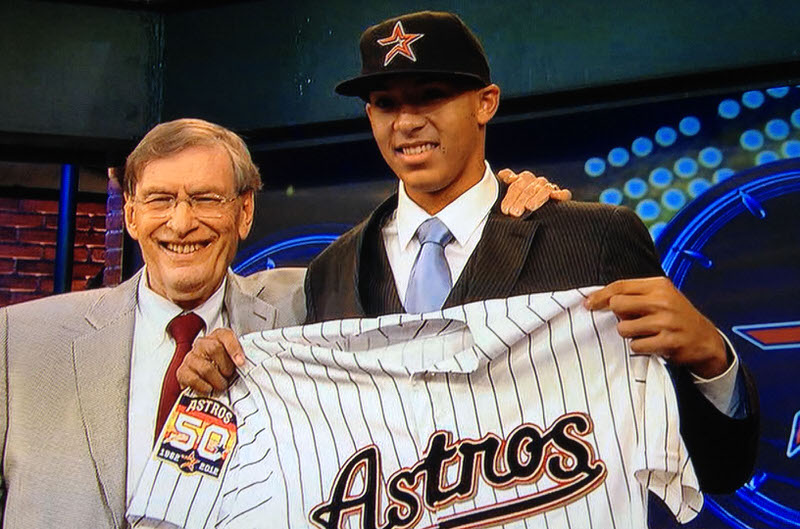 Carlos Correa holding Houston Astros jersey after being drafted