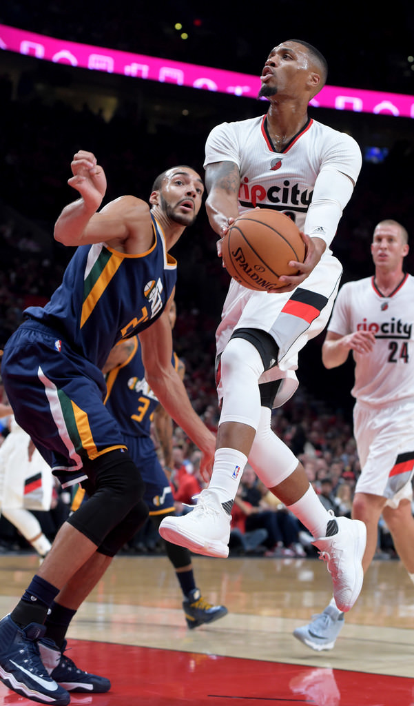 Damian Lillard drives in the all-white adidas D Lillard 2 Primeknit