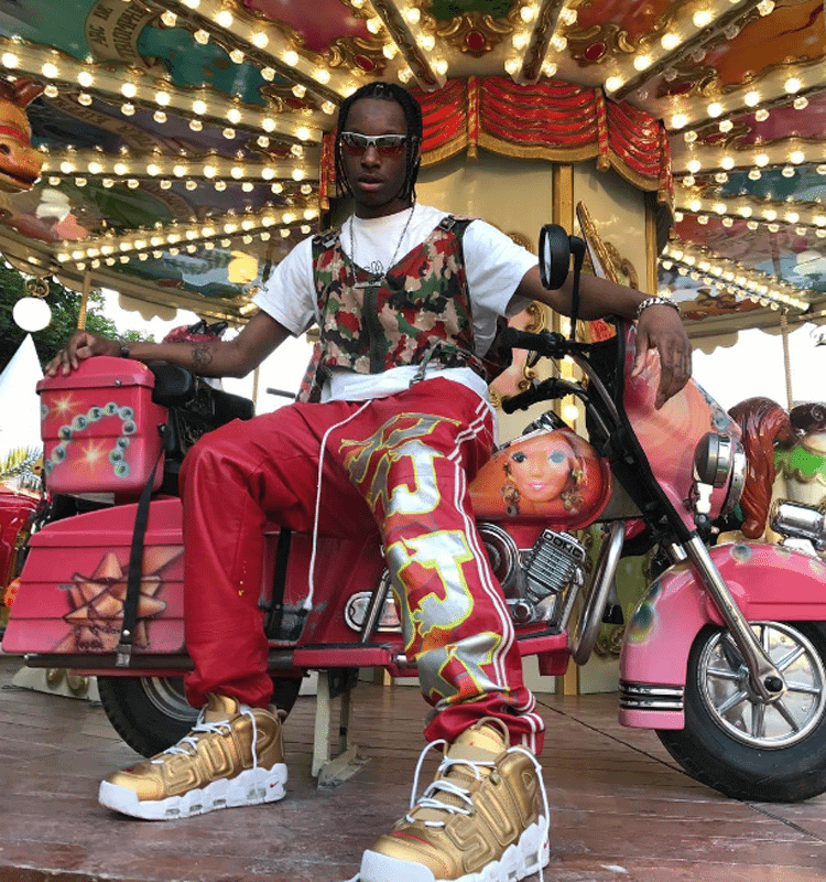 Bloody Osiris combines warm-up pants with a floral pattern vest with the Supreme x Nike Air More Uptempo.