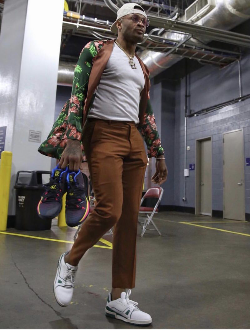 PJ Tucker wears Palm Angels Jacket with cropped trousers and Louis Vuitton LV Trainers.