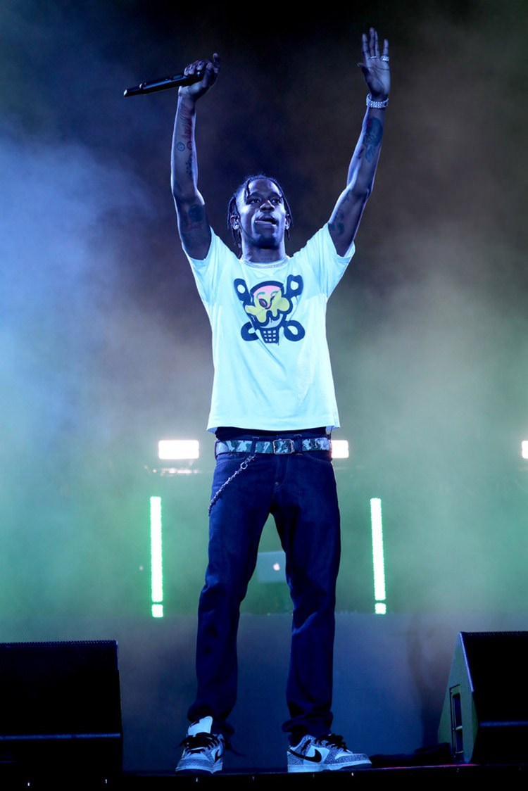 Like it's the mid 2000s. Travis pairs his Supreme Dunk Lows with an Ice Cream tee. 