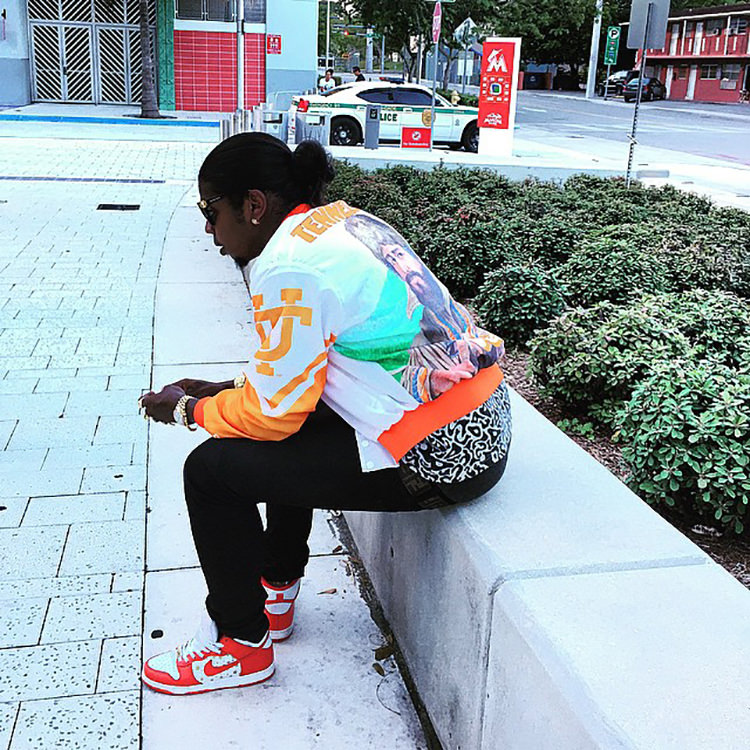 Trinidad James wears the Supreme x Nike SB Dunk High with University of Tennessee warm-up jacket.